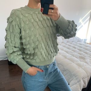 Sage green texture knit sweater with sleeve details. The brand is Wild Flower